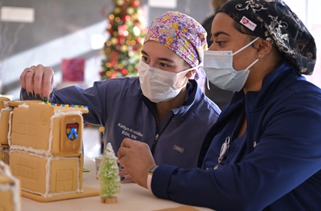 Princeton Health staffers decorating a gingerbread hospital at 2022 Winter Wonderland 
